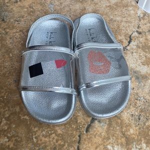 Toddler girl Nicole Miller slides